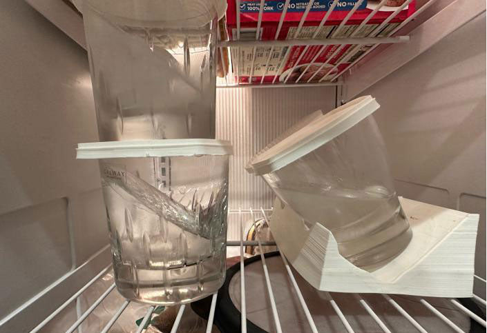 glasses with frozen ice and lids on in freezer