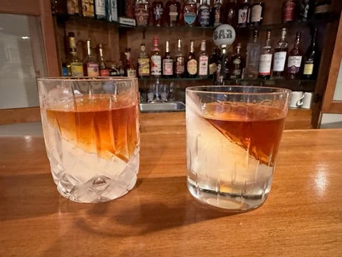 two whiskey glasses with ice wedges frozen inside